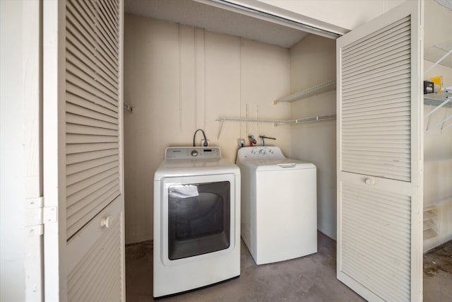 clothes washing area featuring independent washer and dryer