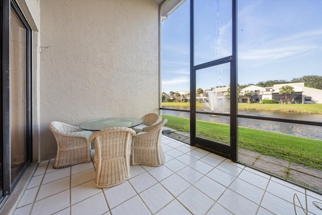 sunroom with a water view and a healthy amount of sunlight