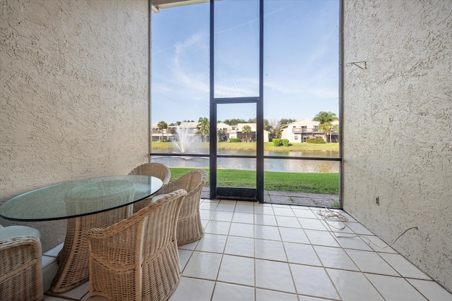 unfurnished sunroom with a water view