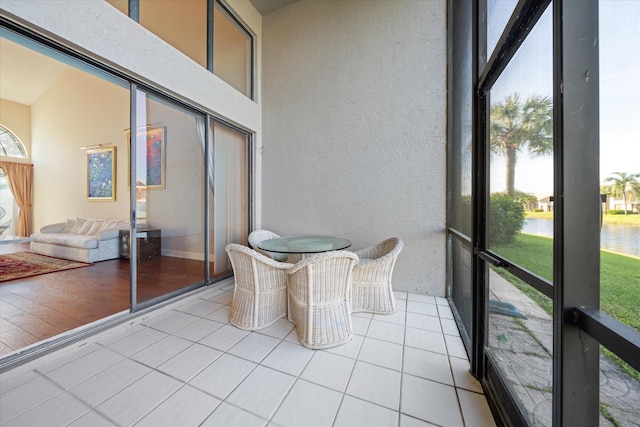 unfurnished sunroom featuring a water view