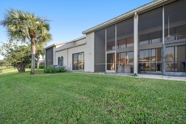 rear view of property featuring a lawn