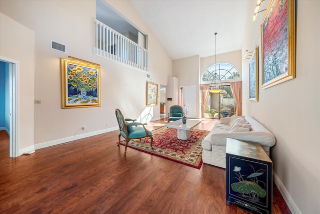 living room featuring high vaulted ceiling and dark wood-type flooring