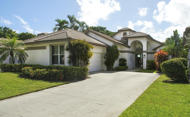 view of front of property with a garage and a front yard