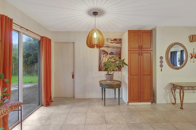 tiled dining area featuring a textured ceiling