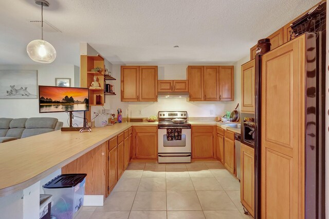 kitchen featuring a textured ceiling, light tile patterned floors, decorative light fixtures, and appliances with stainless steel finishes