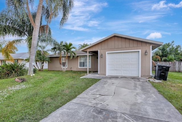 single story home featuring a front lawn and a garage