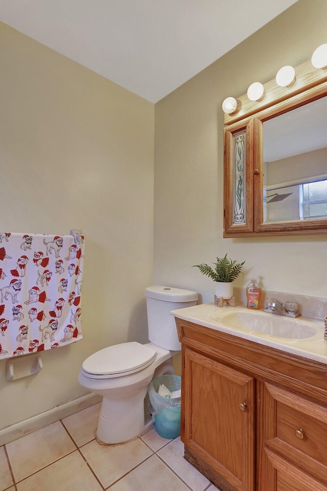 bathroom featuring tile patterned flooring, vanity, and toilet