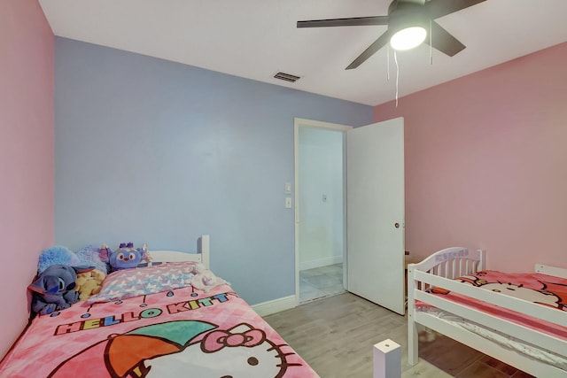 bedroom with light hardwood / wood-style floors and ceiling fan