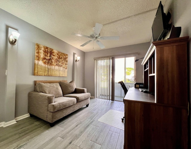 office space with a textured ceiling, light hardwood / wood-style flooring, and ceiling fan