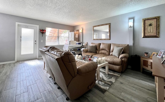 living room featuring a textured ceiling and light hardwood / wood-style flooring