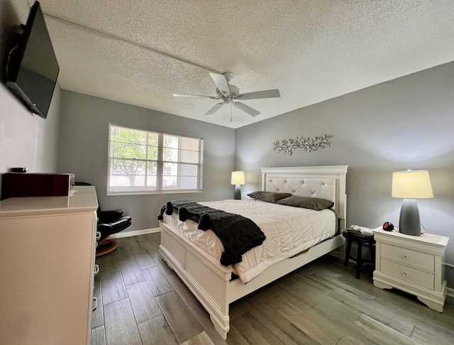 bedroom featuring wood-type flooring, a textured ceiling, and ceiling fan