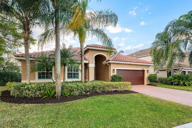 mediterranean / spanish-style house with a front yard and a garage