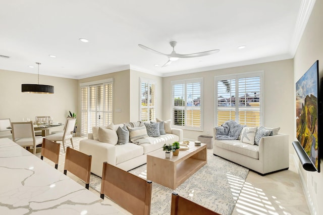 living room with ceiling fan and ornamental molding