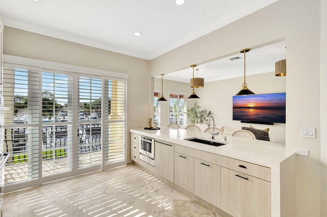 kitchen with pendant lighting, oven, crown molding, and sink