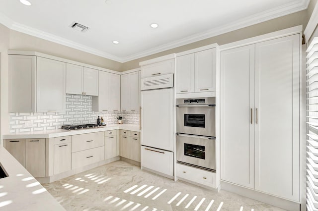 kitchen featuring backsplash, crown molding, and stainless steel appliances