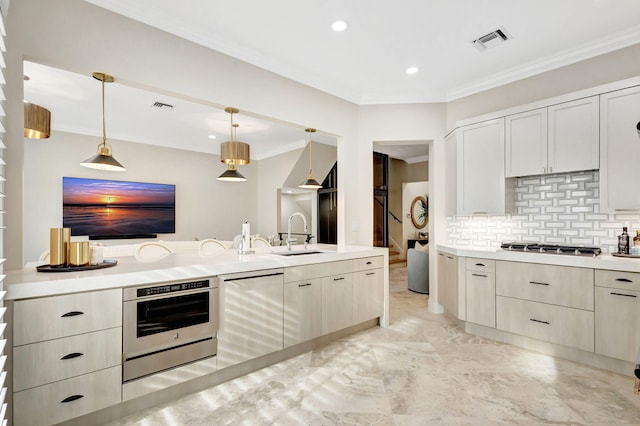 kitchen with decorative backsplash, sink, hanging light fixtures, and stainless steel appliances