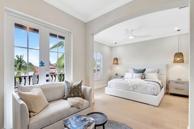 bedroom featuring access to exterior, ceiling fan, french doors, light hardwood / wood-style flooring, and ornamental molding