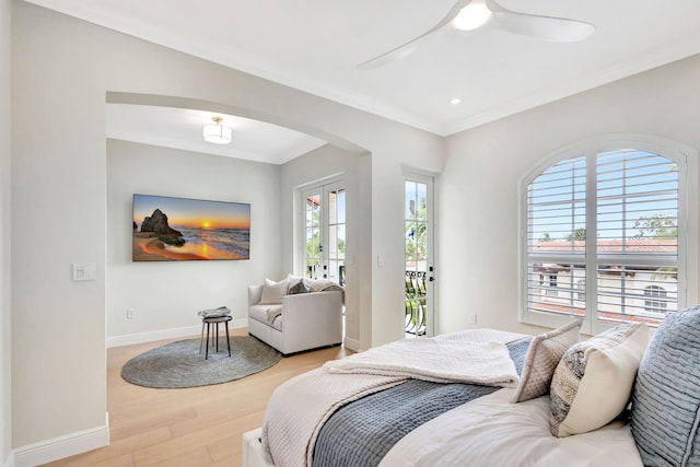 bedroom with access to outside, french doors, ceiling fan, light wood-type flooring, and ornamental molding