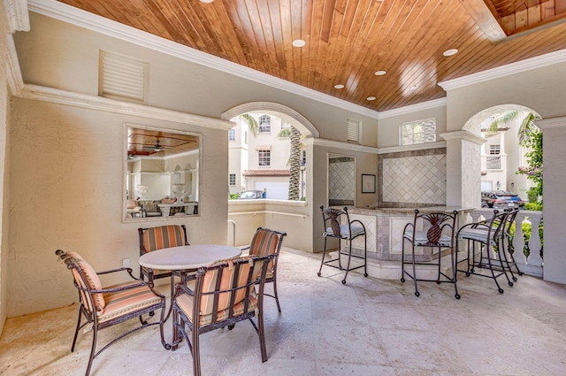 dining space featuring wooden ceiling and ornamental molding