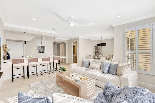 living room featuring ceiling fan and crown molding