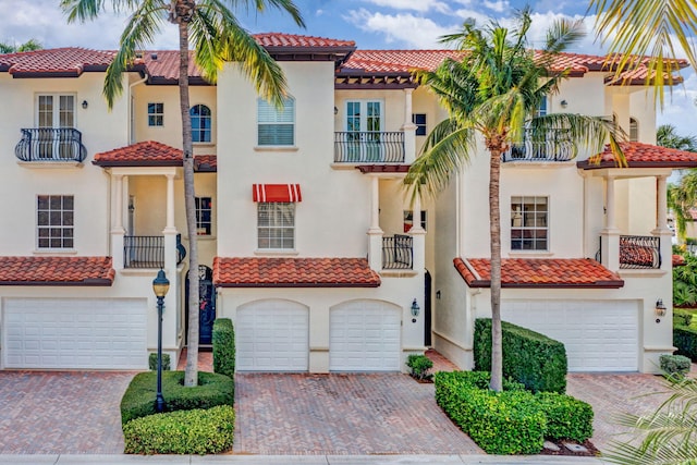 mediterranean / spanish-style house with a garage