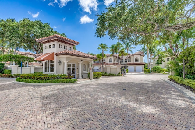 mediterranean / spanish-style house with a garage