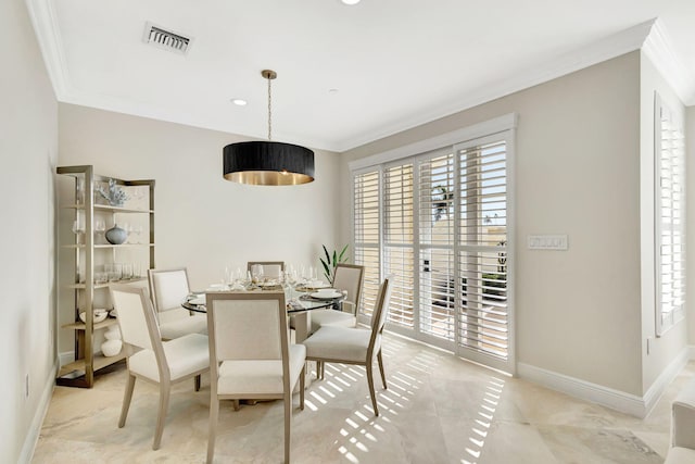 dining room with a healthy amount of sunlight, light tile patterned floors, and crown molding