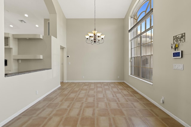 unfurnished dining area featuring an inviting chandelier