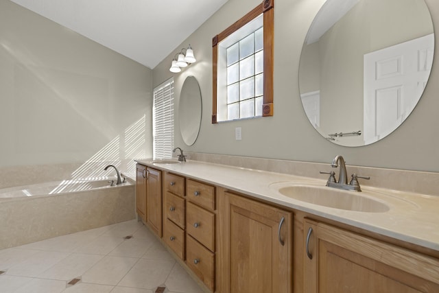 bathroom featuring vaulted ceiling, tile patterned floors, a bath, and vanity