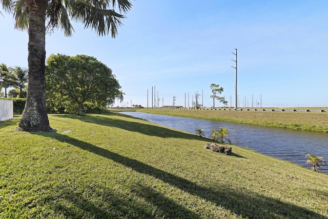 exterior space featuring a water view and a yard