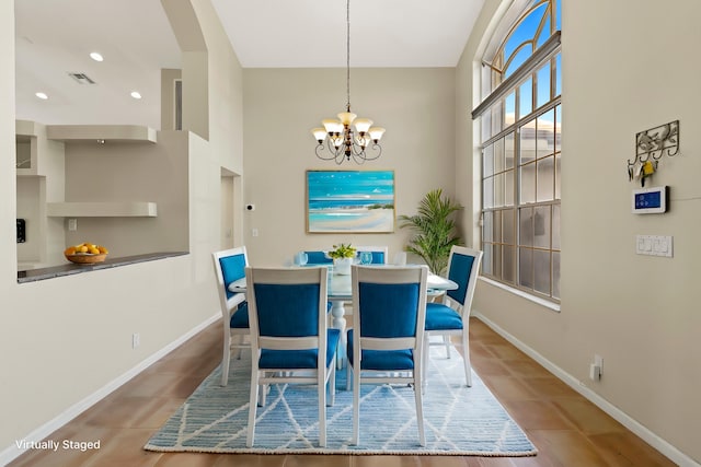 dining space with an inviting chandelier and tile patterned floors