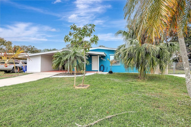 view of front of property with a front yard and a carport