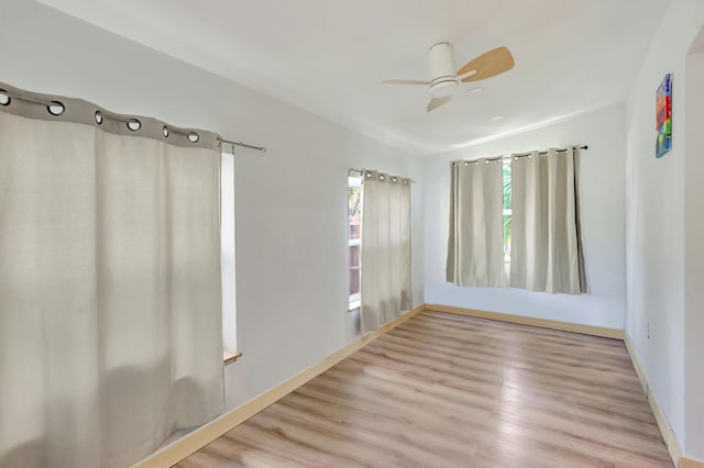 empty room featuring light wood-type flooring and ceiling fan