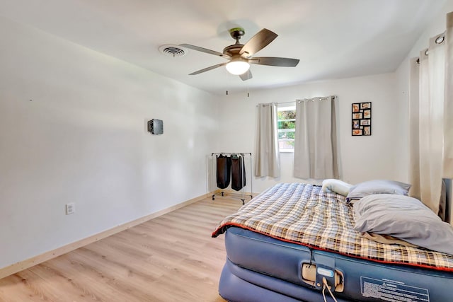 bedroom with ceiling fan and light wood-type flooring