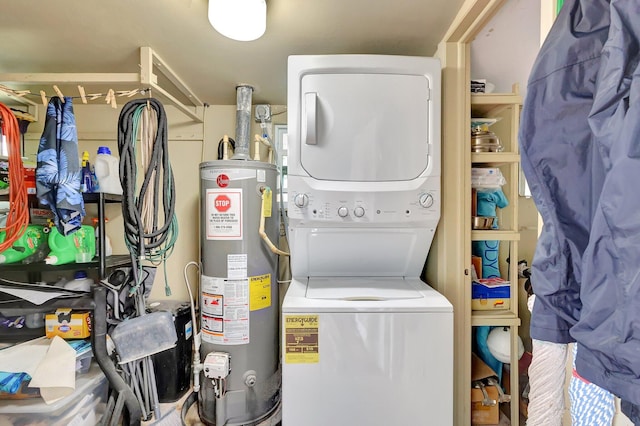 laundry room with stacked washer / drying machine and water heater