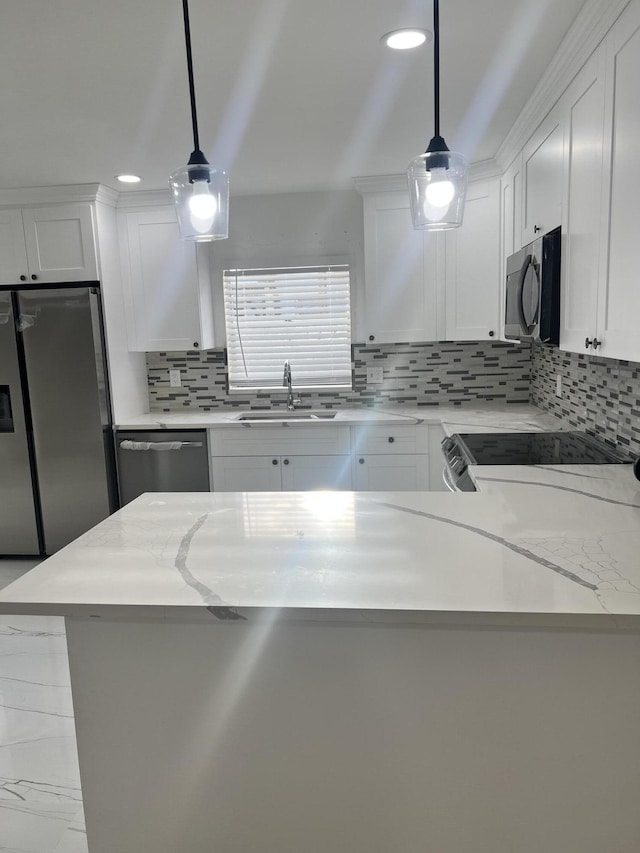 kitchen with sink, white cabinets, pendant lighting, and appliances with stainless steel finishes