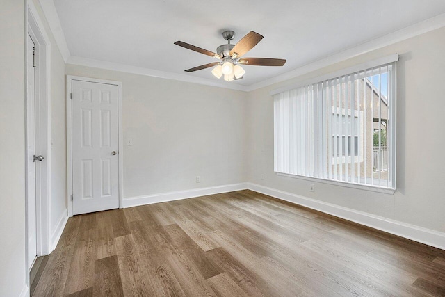 unfurnished room with crown molding, ceiling fan, and wood-type flooring