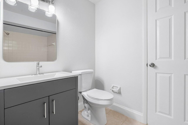 bathroom featuring tile patterned flooring, vanity, and toilet