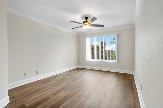 empty room with ceiling fan, wood-type flooring, and crown molding