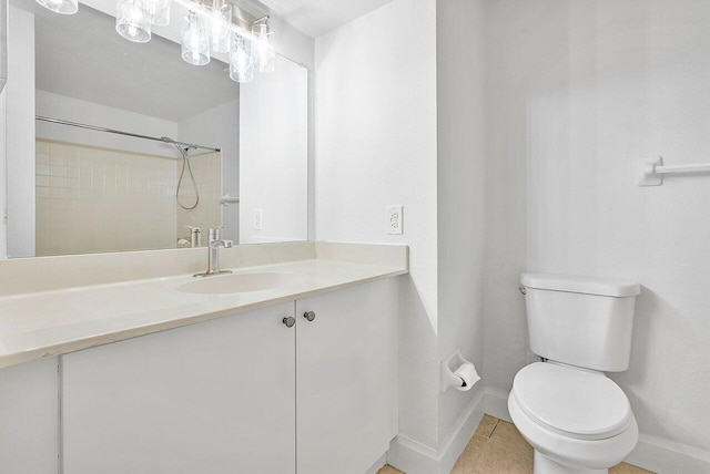 bathroom featuring a shower, tile patterned flooring, vanity, and toilet