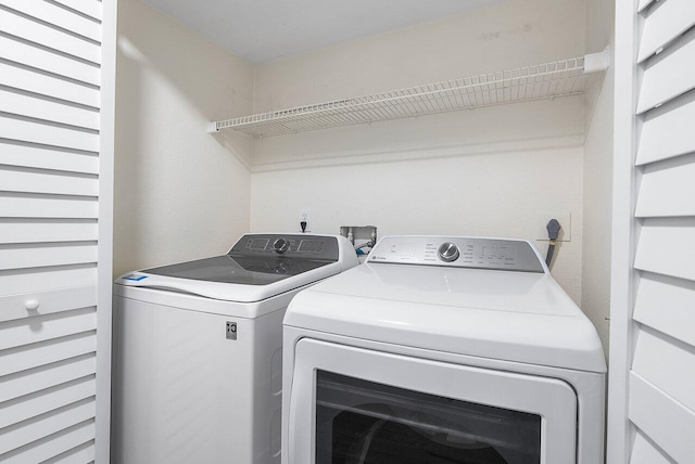 clothes washing area featuring washer and dryer