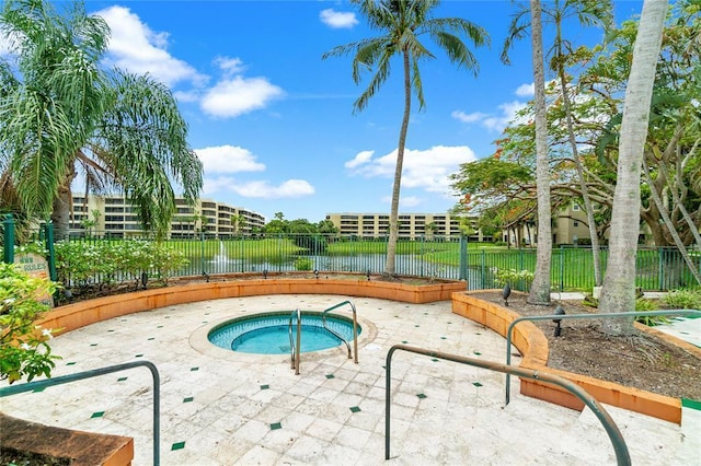 view of swimming pool with a water view and an in ground hot tub