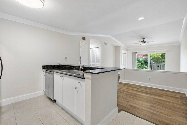 kitchen featuring kitchen peninsula, light hardwood / wood-style flooring, white cabinetry, and dishwasher