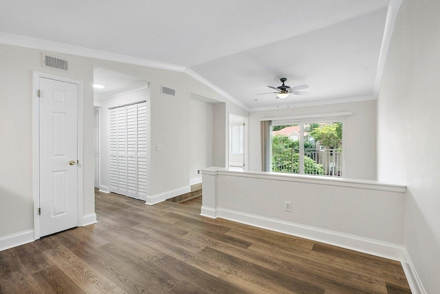 unfurnished room featuring dark hardwood / wood-style flooring, vaulted ceiling, ceiling fan, and crown molding