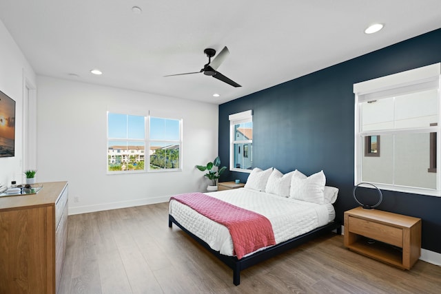 bedroom featuring hardwood / wood-style flooring and ceiling fan