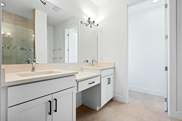 bathroom with tile patterned flooring, vanity, and walk in shower