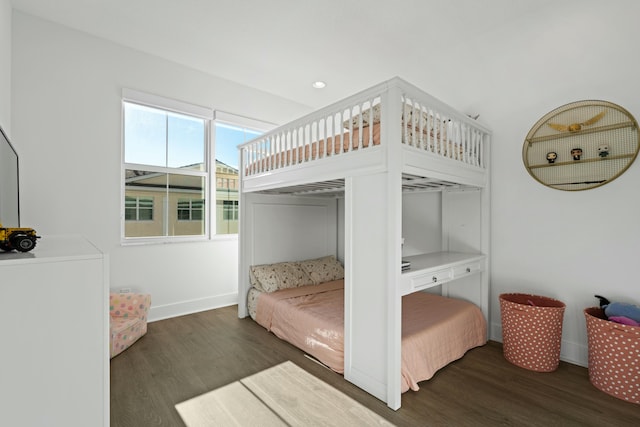 bedroom with dark hardwood / wood-style floors