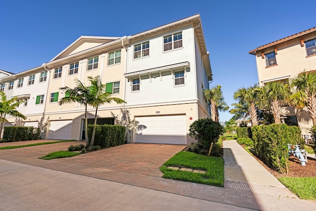 townhome / multi-family property featuring a garage