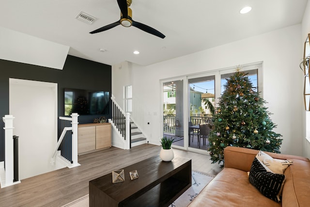 living room with ceiling fan and light wood-type flooring