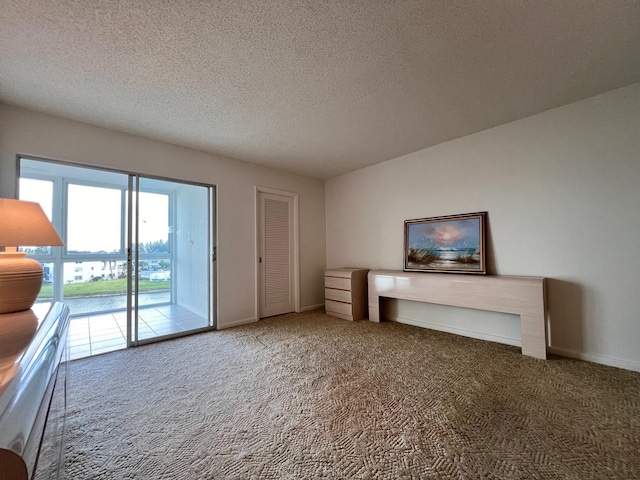 unfurnished living room with carpet and a textured ceiling